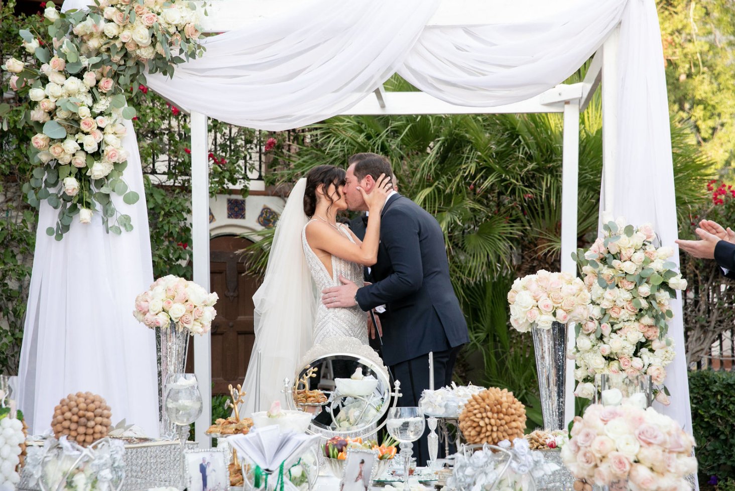 Banquet table florals beside a garden fountain